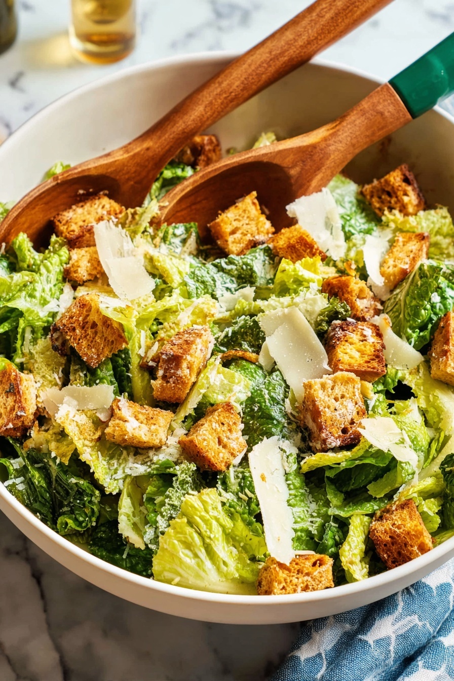 A white bowl filled with a fresh Caesar salad shows several layers: the base layer has green romaine lettuce leaves with a crisp texture, topped with golden brown toasted croutons that have a crunchy appearance, and thin, pale yellow slices of Parmesan cheese scattered evenly. On top, a creamy dressing lightly coats parts of the salad. Two wooden salad tongs with green handles rest inside the bowl on the right side. In the background, there are two stacked white plates with three old-fashioned forks resting on them, a glass filled with white wine being poured from a green bottle with a blue label, and a blue cloth with white triangle shapes, all set on a white marbled surface. photo taken with an iphone --ar 2:3 --v 7