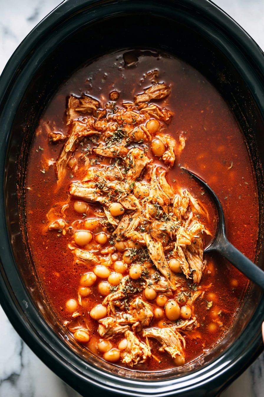 A white deep bowl filled with a rich red broth containing light brown shredded chicken pieces and large white hominy kernels spread throughout. On one side, thin slices of white and red radishes along with light green shredded cabbage are layered neatly. A bright green lime wedge rests on the right edge of the bowl. Fresh green cilantro leaves are sprinkled over the soup, adding a touch of vibrant color. A black spoon is placed inside the bowl, with its handle resting on a yellow cloth. The entire setting is on a white marbled surface with extra lime wedges, cilantro sprigs, and a small bowl of shredded cabbage nearby. Photo taken with an iphone --ar 2:3 --v 7