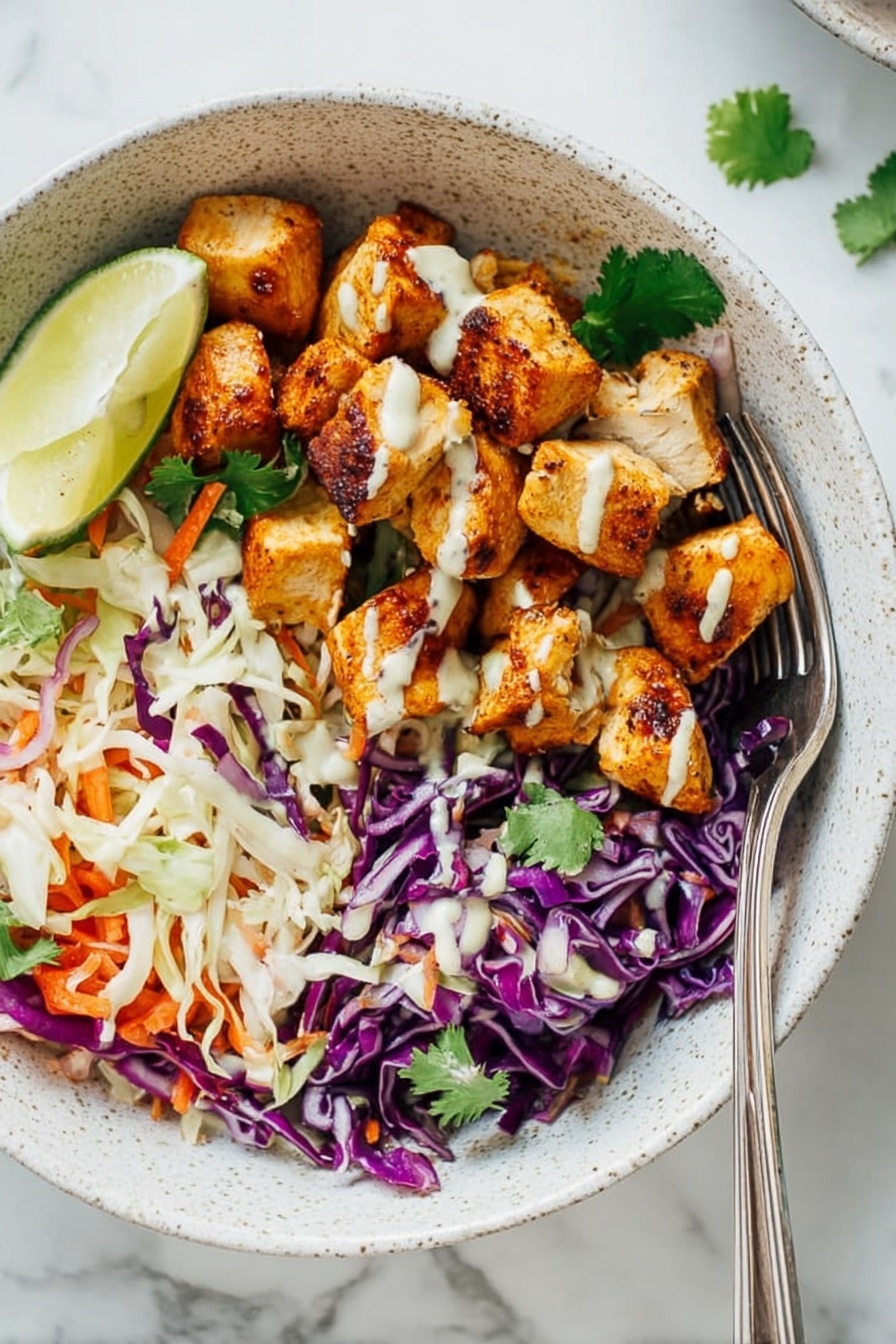 A white speckled bowl holds a colorful layered salad. The bottom layer is fresh shredded cabbage in purple and white, mixed with thin orange carrot strips and green cilantro leaves. On the right side of the bowl, there are golden brown cooked chicken pieces with a light sauce drizzled over them. A bright green lime wedge sits on the top left edge of the bowl. Around the bowl on a white marbled surface are extra lime slices, green cilantro sprigs, and some sauce drops. Nearby, two more white bowls with a similar salad can be seen. Photo taken with an iphone --ar 2:3 --v 7