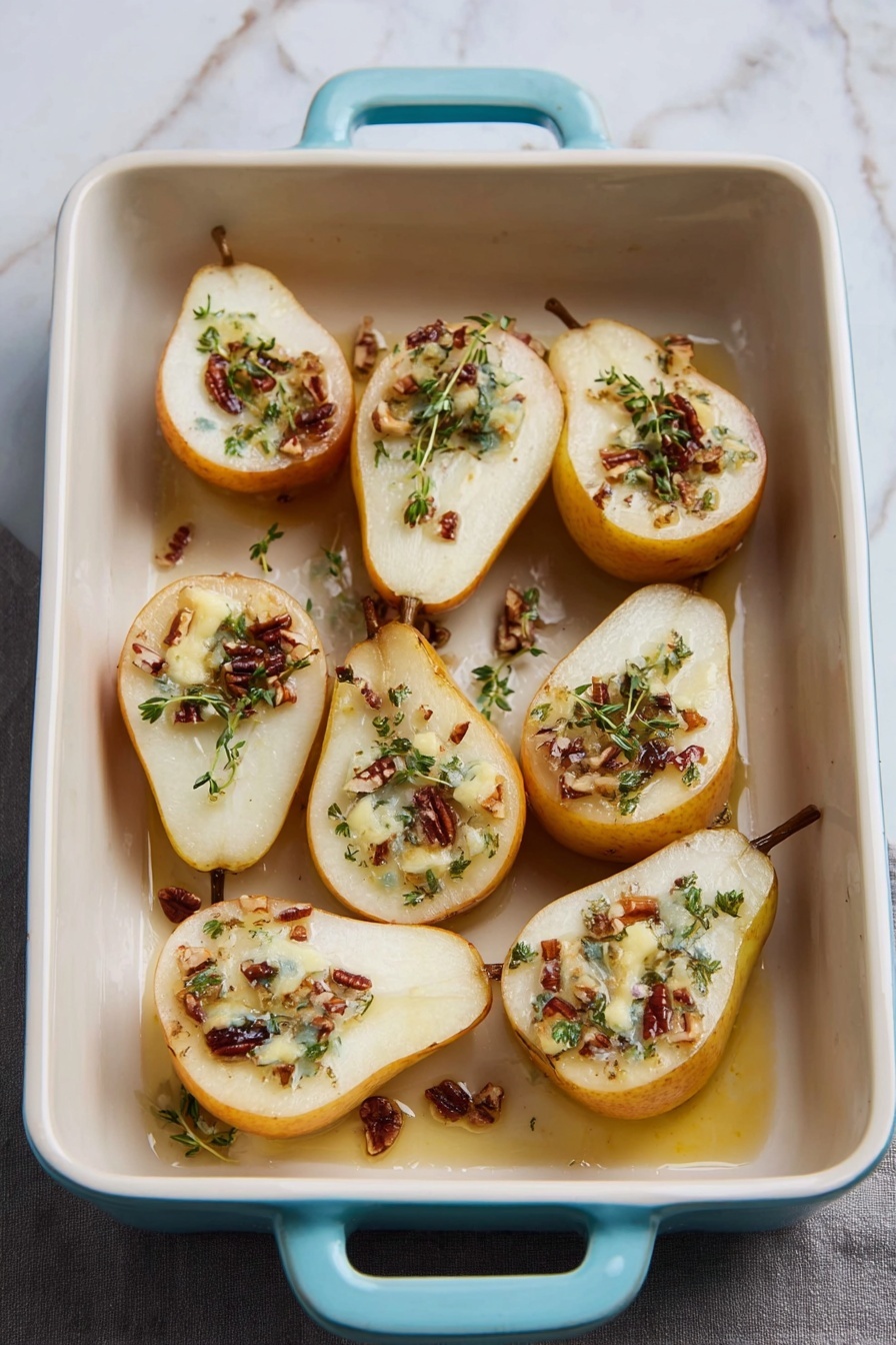 A white rectangular baking dish with pale blue handles holds eight halves of baked pears arranged in two rows. Each pear half has a light golden-brown outer skin and is filled with a topping made of melted creamy white cheese, small pieces of brown nuts, and small green herb leaves scattered on top. The pears are slightly soft with a smooth texture, and there are hints of syrup or juice pooling around them inside the dish. The background is a white marbled surface with some green herbs and a yellow whole pear partially visible in the top left corner photo taken with an iphone --ar 2:3 --v 7
