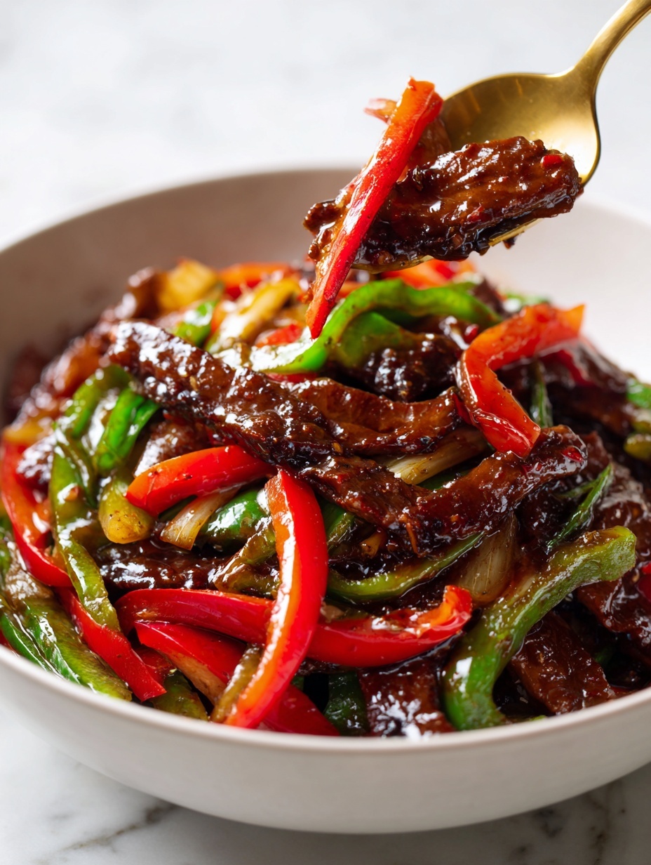 The dish shows slices of dark brown beef cooked in a shiny, thick brown sauce, mixed with long strips of red and green bell peppers. The beef pieces are tender and scattered evenly across the dish, with the sauce giving a glossy look to the whole mix. The bright red and green bell peppers add a fresh and crisp contrast to the dark beef, and everything is contained in a shallow white pan on a white marbled surface. photo taken with an iphone --ar 2:3 --v 7