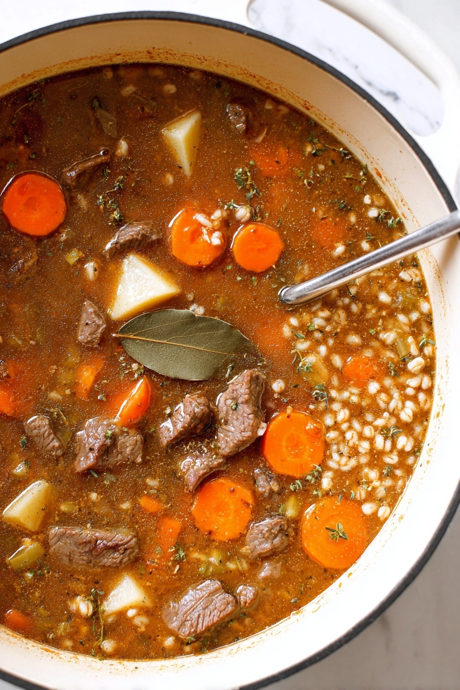 The image shows a large white pot filled with thick beef stew, featuring layers of dark brown beef pieces, bright orange carrot slices, light yellow potato chunks, and small pieces of celery submerged in a rich brown broth. The broth has visible seasoning flecks and a bay leaf floating on top, with some barley or grain mixed in. A metal spoon is partially immersed in the stew on the right side. The pot sits on a white marbled surface. photo taken with an iphone --ar 2:3 --v 7