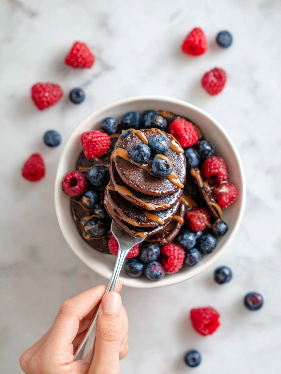 A clear blender container holds a stack of ingredients ready to mix: a layer of light beige rolled oats with coarse texture sits at the bottom left corner, topped with creamy light yellow banana slices placed around the sides. Next to the banana are powdered and loose cacao brown powders scattered on top, with a dollop of thick white yogurt or cream visible on the upper right. A scoop of light tan flour-like powder lays on top near the center, and the shiny metal blender blade with a slight curve cuts through the middle. The whole setup is on a white marbled surface photo taken with an iphone --ar 2:3 --v 7