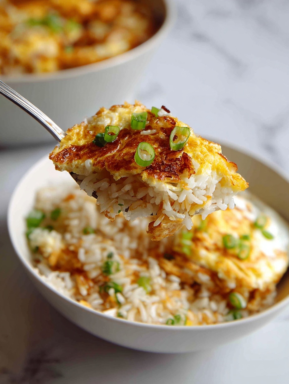 A close-up image shows a spoon lifting a mix of white rice with a golden brown crispy edge and bright yellow runny egg yolk inside a white bowl with blue vertical stripes on the inside. The rice is mixed with small green onion pieces scattered throughout. The crispy parts of the egg around the yolk have a rich brown and orange color, adding texture contrast to the soft rice and liquid yolk. The bowl rests on a white marbled surface. Photo taken with an iphone --ar 2:3 --v 7