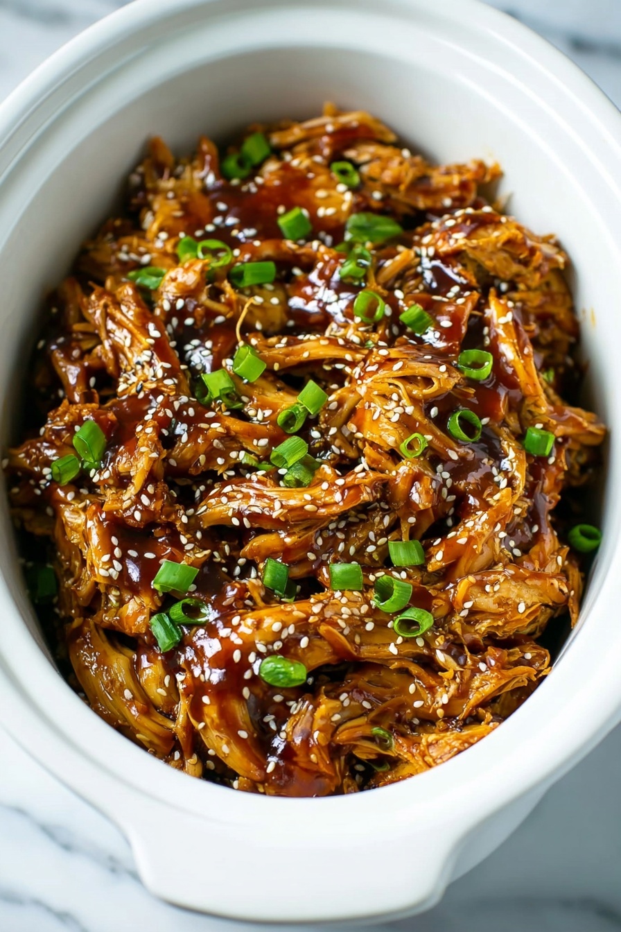 A white slow cooker filled with shredded meat covered in a thick, shiny, brown sauce, topped with small white sesame seeds and chopped bright green onions scattered evenly across the surface, with the texture of the meat showing soft, fibrous strands under the rich sauce. The background is a white marbled texture photo taken with an iphone --ar 2:3 --v 7