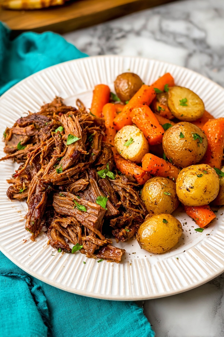 The image shows a white plate with two main layers of food placed on a white marbled surface. On the left, there is a thick layer of shredded brown meat with a slightly crispy texture on top, garnished with small green leaves. On the right side, there is a mix of small, round, golden yellow potatoes and orange carrot pieces, all with a slightly roasted look and sprinkled with herbs. The colors are warm, and the food looks moist and tender, with a cozy and hearty appeal. Photo taken with an iphone --ar 2:3 --v 7